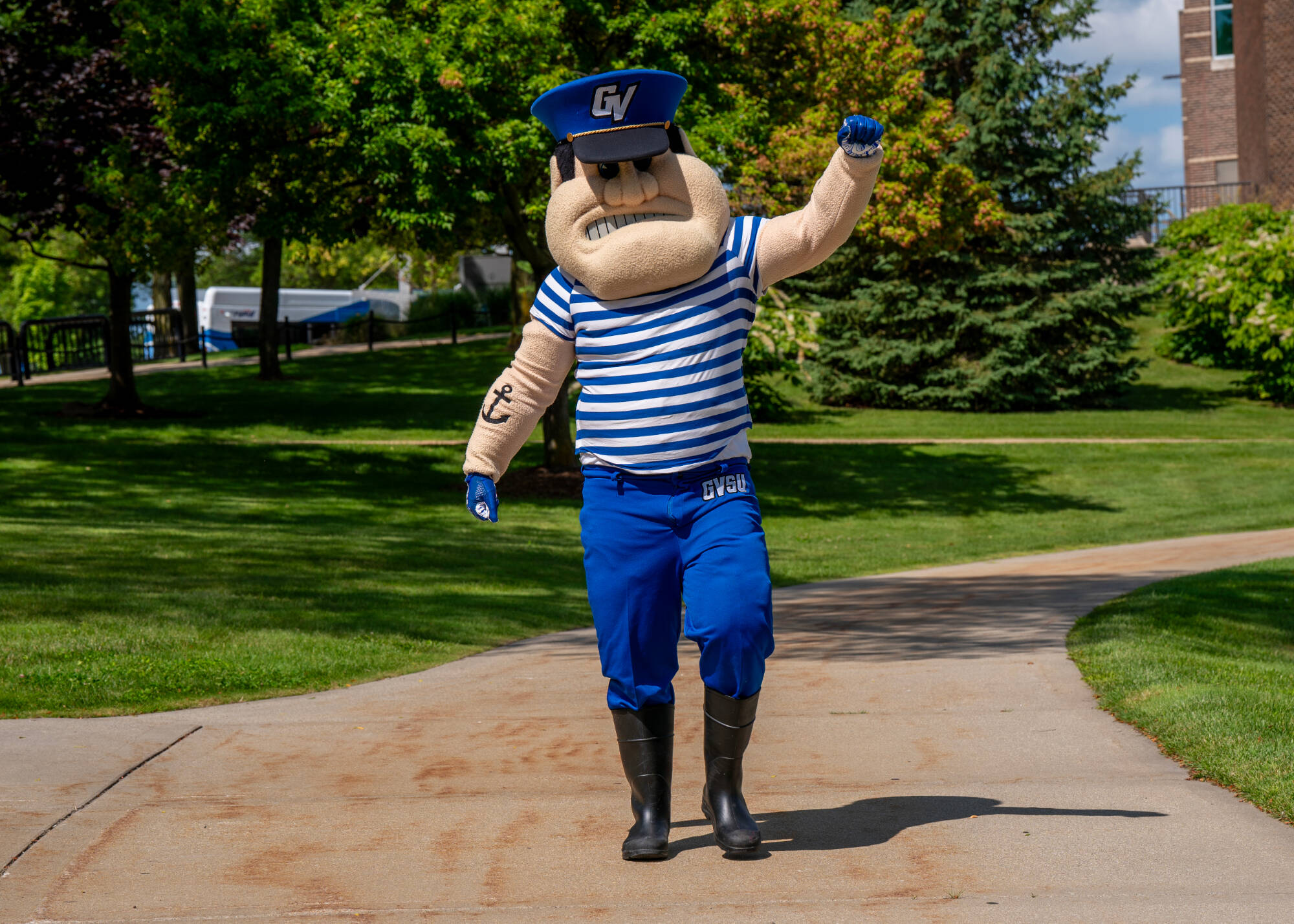 Louie The Laker waving while on a walk on campus